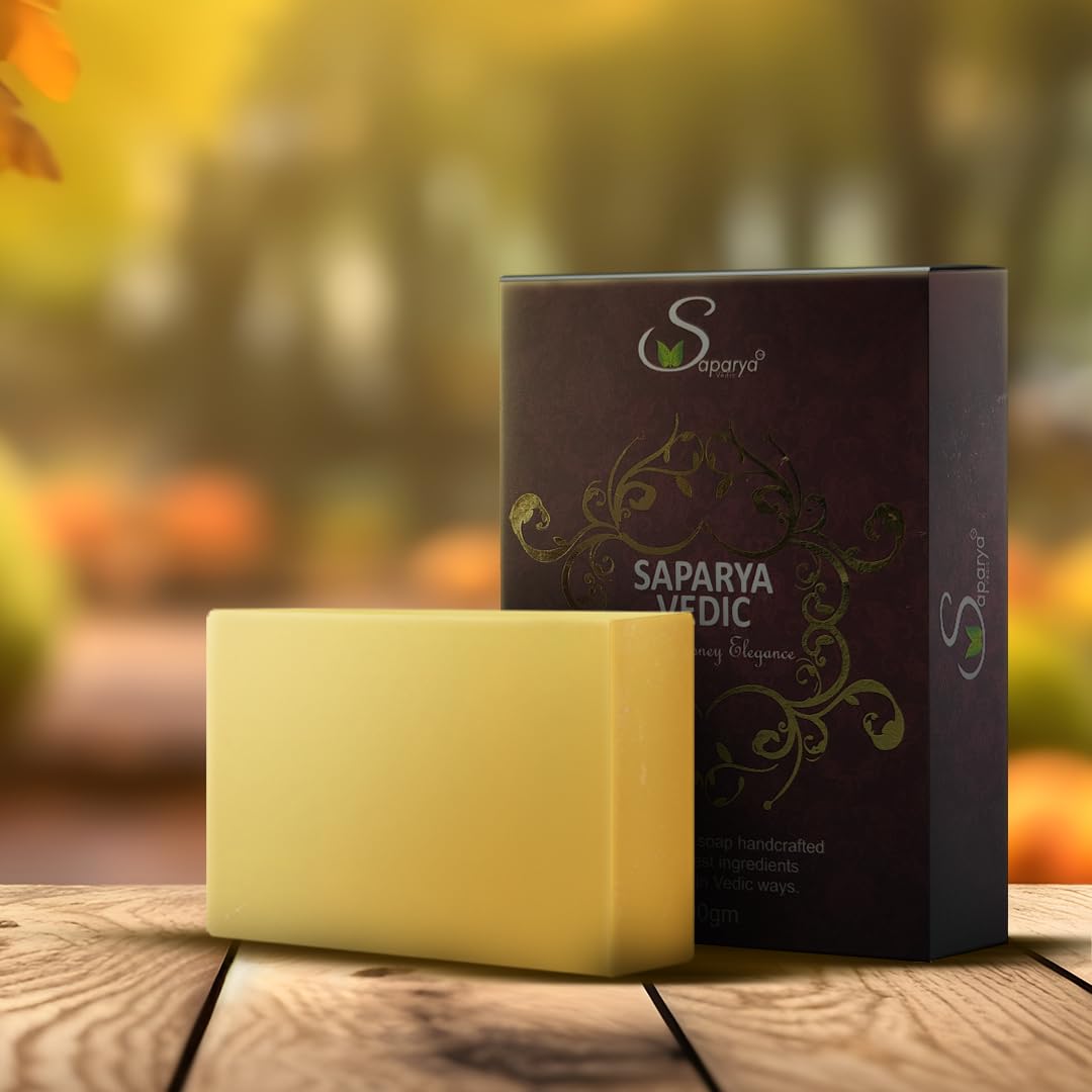 Yellow bar of soap and its packaging with Saparya branding on a wooden surface.